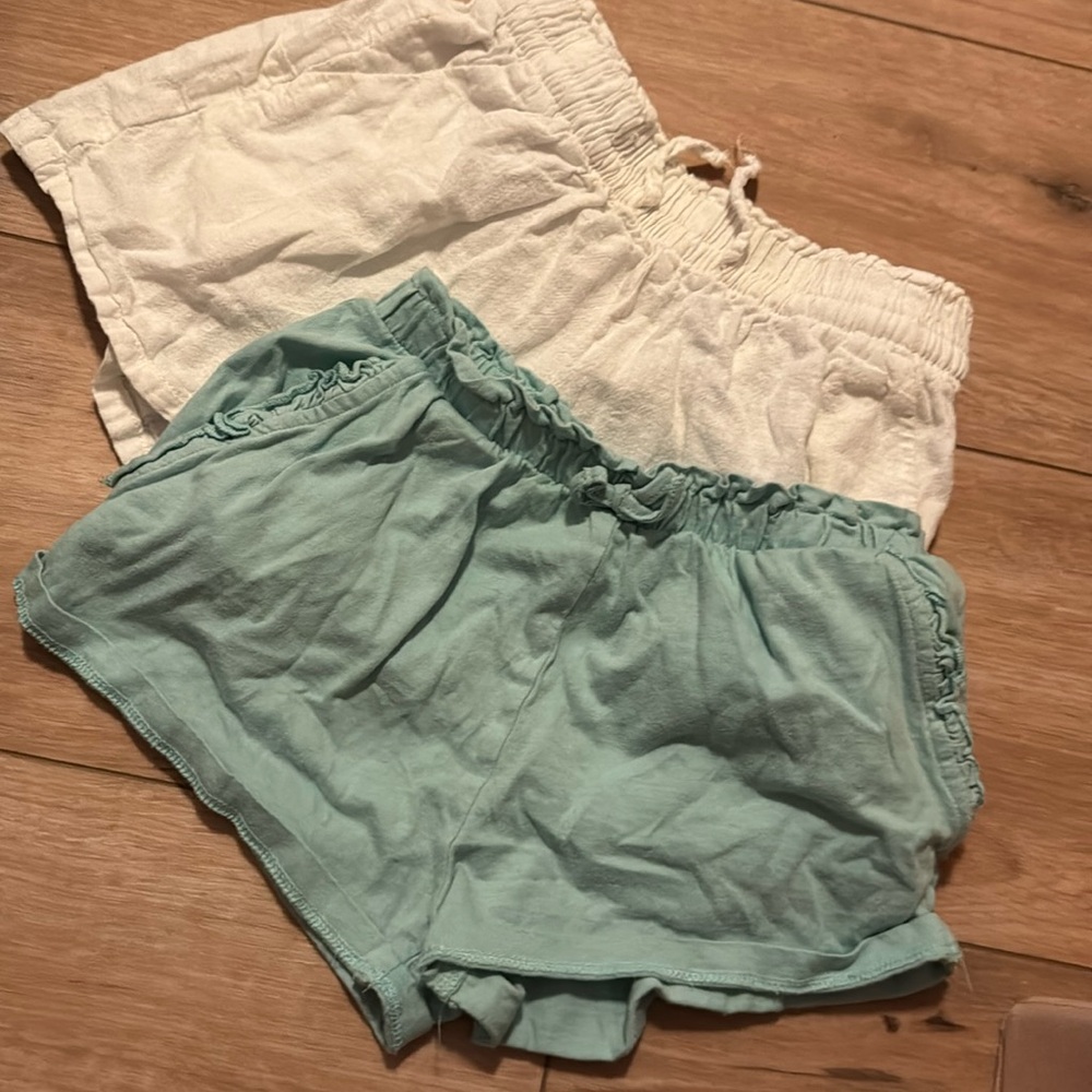 Two pairs of shorts lightly worn. White 54% lines 46% cotton green 100% cotton
